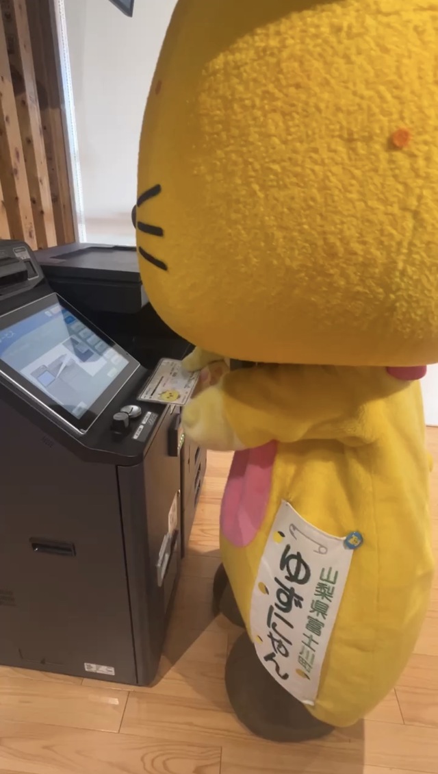 キオスク端末の指示に従うゆずにゃん、マイナンバーカードを使用する前。